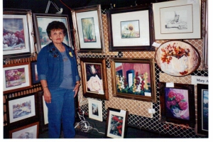 Local artist Mary Ann Allen with her award winning paintings at the Arts on the Square in Hobart.